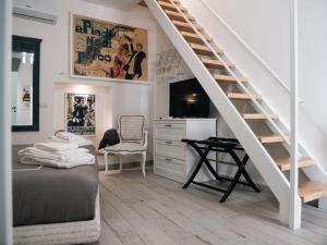 a bedroom with a bed and a desk and a staircase at Opera Prima Apartment and Room in Altamura