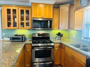 a kitchen with wooden cabinets and a stove top oven at Clamelot in Holden Beach