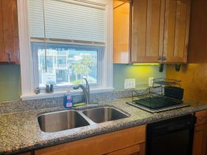 a kitchen counter with a sink and a window at Clamelot in Holden Beach