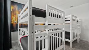 two white bunk beds in a room at Wonderful Villas 18 Minutes away from Disney! in Kissimmee