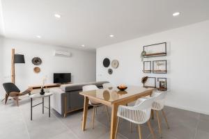 a living room with a table and a couch at Gaivota Ocean view & 5min walk beach in Luz