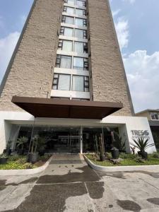 a tall building with a large building at Senua - Moderno y artistico apartamento in Guatemala