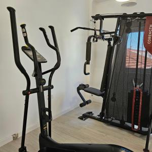 a gym with two treadmills and a treadmill at Marinha Garden Inn in Marinha Grande