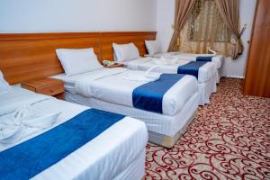 - un groupe de 4 lits dans une chambre d'hôtel dans l'établissement فندق ليمة الفضية - Leema Al Fadya Hotel, à La Mecque