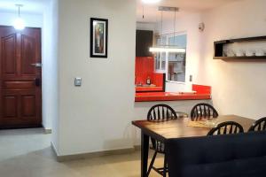 a dining room and kitchen with a table and chairs at Zely home # 4 in Cancún