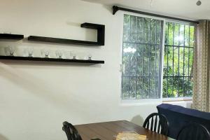 a dining room with a table and a window at Zely home # 4 in Cancún