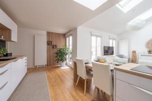 a kitchen and living room with a table and chairs at Appartement Fransokyo - Welkeys in Serris +18 photos