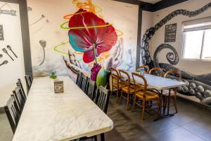 a dining room with a table and a flower mural at Hotel Rose Ensenada in Ensenada