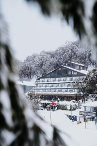 a hotel in the snow with a building at Falls Creek Hotel in Falls Creek