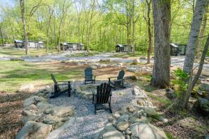 a group of three chairs sitting in a park at Farmhouse Tiny home with fishing Pond - Oak Cabin in Gatlinburg