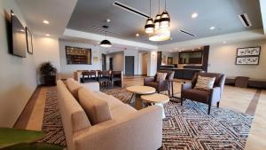 a lobby with a couch and chairs and a table at Candlewood Suites - Lake Charles South by IHG in Lake Charles