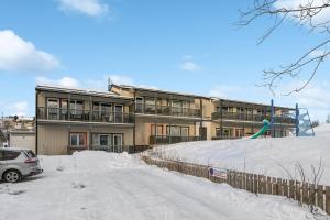 a building with a playground in the snow at Studioleilighet, uten soverom in Bodø