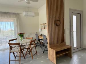 a kitchen and dining room with a table and chairs at Verano Retreat in Chania