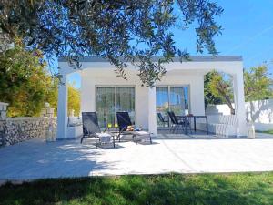 un patio con sillas y una mesa frente a una casa en Rhodes Soul luxury suites en Afántou