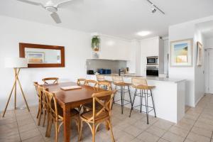 a kitchen and dining room with a table and chairs at 7 28 Duke Street Sunshine Beach in Sunshine Beach