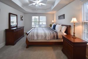 a bedroom with a bed and a dresser and windows at Lakeview Dreams in Young Harris