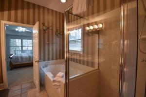 a bathroom with a shower and a bath tub at Lakeview Dreams in Young Harris