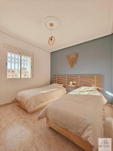 a bedroom with two beds and a window at Casa Miramar in Ciudad Quesada