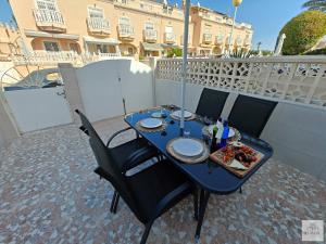 a blue table with food on top of a balcony at Casa Miramar in Ciudad Quesada