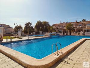 a large swimming pool with blue water at Casa Miramar in Ciudad Quesada