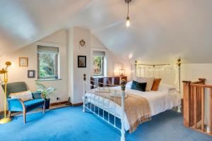 a bedroom with a bed and a blue carpet at Rock Cottage in Llanfyllin