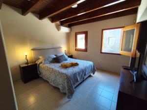 a bedroom with a dog laying on a bed at Chacras de Coria Los Robles in Chacras de Coria