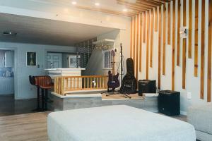 a living room with a bed and a guitar at Beautiful Home with Bay View minutes from AC in Pleasantville