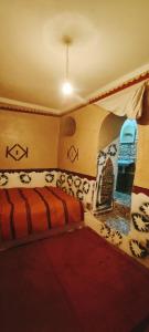 a bedroom with a bed in a room with animals on the wall at Riad DAR outebba 