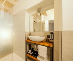 a bathroom with a sink and a mirror at Il Vicolo Suite Apartments-Il Cortiletto in Tignale