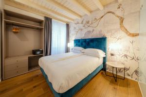מיטה או מיטות בחדר ב-Il Vicolo Suite Apartments-Il Cortiletto