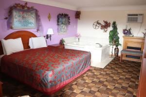 1 dormitorio con cama y bañera en Best Nights Inn - Sparta, en Sparta