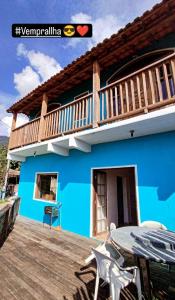 a house with a blue house with a balcony at Refúgio na Praia in Ilhabela