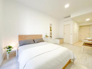 biała sypialnia z dużym łóżkiem i łazienką w obiekcie Estudio en Malaga centro w Maladze