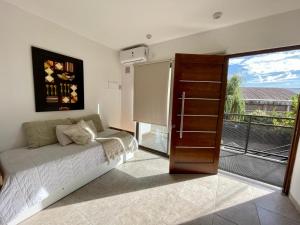 a bedroom with a bed and a sliding glass door at Florencia Hospedaje in Tupungato