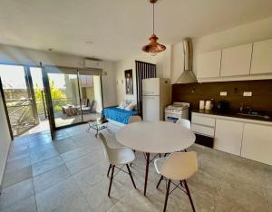 a kitchen with a table and chairs in a kitchen at Florencia Hospedaje in Tupungato