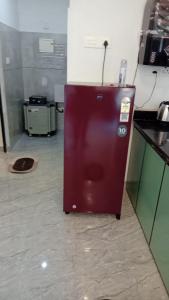 a kitchen with a red refrigerator in a room at Bekal Village Homestay in Kāsaragod