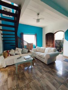 a living room with a white couch and a table at Refúgio na Praia in Ilhabela