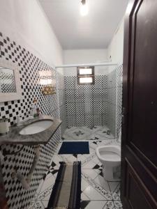 a bathroom with a sink and a toilet at Refúgio na Praia in Ilhabela