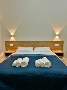 - un lit bleu avec 3 serviettes blanches dans l'établissement M25 Aparts, à Lviv