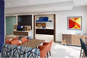 a waiting room with a table and chairs at Holiday Inn Express Suites Little Rock West, an IHG Hotel in Little Rock