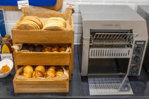 two trays of breads and a bread machine at Holiday Inn Express London Croydon, an IHG Hotel in Croydon