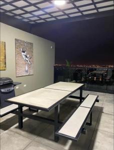 a table and benches in a room with a view at Santa Lucia Lofts Duplex in Cali