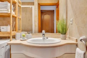 a bathroom with a sink and a mirror at Casita Bonita - with private garden near beach in Jávea in Jávea