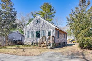 a small house with a staircase in the front yard at Cozy Rhode Island Retreat with Yard, Near Beaches! in North Kingstown