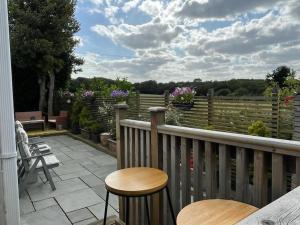 een patio met 2 stoelen en een tafel op een balkon bij Sunset View in Gillingham