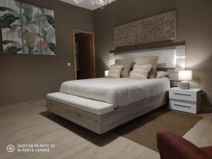 a bedroom with a large bed with white sheets and pillows at SPA HOUSE 2 in Tías