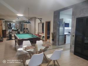 a living room with a pool table and white chairs at SPA HOUSE 2 in Tías