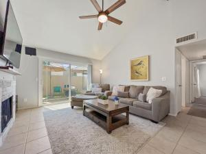 a living room with a couch and a ceiling fan at Lemon Tree #72 Chandler condo in Chandler