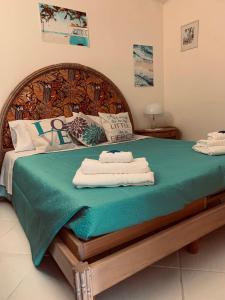 a bedroom with a bed with two towels on it at Villa Liuba in Ischia