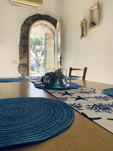a dining room with blue and white mats on a table at Villa Liuba in Ischia